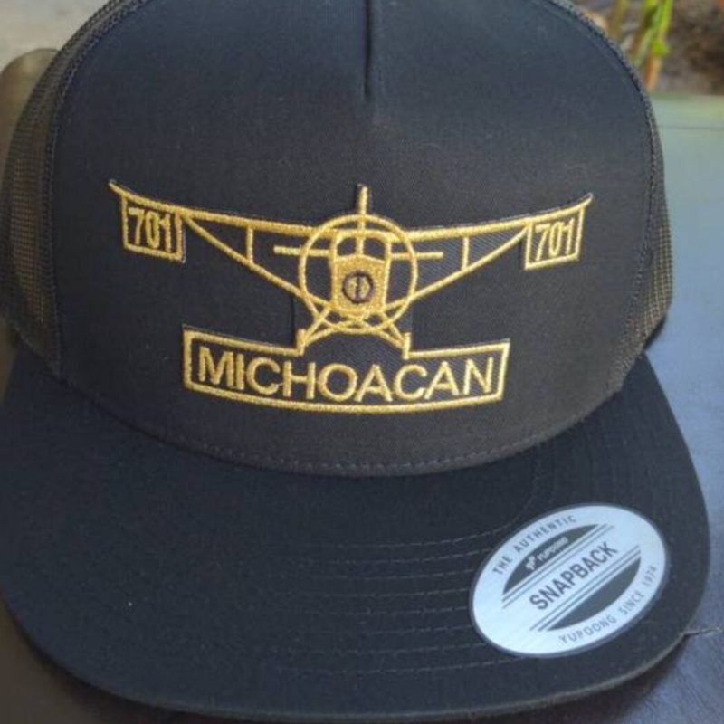 701 Avion Michoacan trucker hat in black featuring gold airplane embroidery and an adjustable snapback closure.